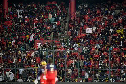 Royal Challengers Bengaluru fans cheer for their team during the Indian Premier League cricket match between Chennai Super Kings and Royal Challengers Bengaluru in Bengaluru, India.
