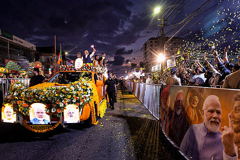 In this image posted on April 4, 2026, Prime Minister Narendra Modi greets supporters during a roadshow ahead of the Kerala Assembly elections, in Thiruvananthapuram.
