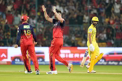 Royal Challengers Bengaluru's Jacob Duffy, center, celebrates the wicket of Chennai Super Kings' captain Ruturaj Gaikwad, right, during the Indian Premier League cricket match between Chennai Super Kings and Royal Challengers Bengaluru in Bengaluru, India.