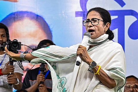 West Bengal Chief Minister Mamata Banerjee with TMC candidates Prasanjit Das (Gazole) and Prasun Banerjee (Chanchal), unseen, during a rally ahead of the Assembly elections, at Gazole, in Malda district, West Bengal.