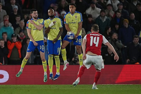 From left: Southampton's Finn Azaz, Clye Larin and Shea Charles jump as Arsenal's Viktor Gyoekeres, right, shoots a free kick during the English FA Cup quaterfinal soccer match between Southampton and Arsenal in Southampton, England.