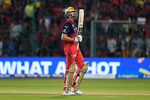 Royal Challengers Bengaluru's Tim David celebrates his fifty runs during the Indian Premier League cricket match between Chennai Super Kings and Royal Challengers Bengaluru in Bengaluru, India.