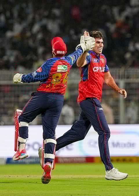 Punjab Kings' Xavier Bartlett, right, celebrates after dismissing Kolkata Knight Riders' Cameron Green during an Indian Premier League (IPL) 2026 cricket match between Kolkata Knight Riders and Punjab Kings at Eden Gardens, in Kolkata.