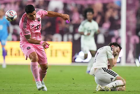 Inter Miami CF forward Luis Suárez, left, heads the ball as Austin FC defender Jon Gallagher, right, reacts during the second half of an MLS soccer match, in Miami. 