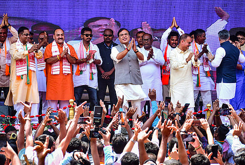 Assam Chief Minister Himanta Biswa Sarma dances during an election campaign in support of BJP candidate Jitu Goswami from Barhampur constituency ahead of the state Assembly elections, in Nagaon, Assam.