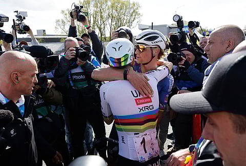 Slovenia's Tadej Pogacar is congratulated by Netherland's Mathieu Van Der Poel afternoon winning the Tour of Flanders cycling race, in Oudenaarde, Belgium.