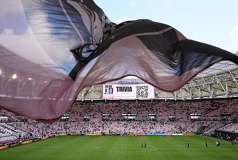 Inter Miami fans wave a flag in Nu Stadium ahead of the team's first MLS soccer match in their new stadium, against Austin FC, in Miami.