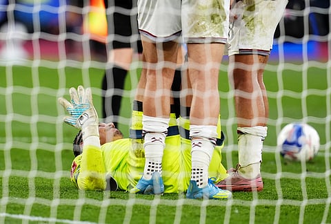 West Ham United goalkeeper Alphonse Areola goes down injured before being replaced by substitute goalkeeper Finlay Herrick in extra-time during the English FA Cup quarterfinal soccer match between West Ham United and Leeds United, in London.