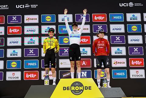 Netherland's Demi Vollering, center, celebrates after winning the Tour of Flanders cycling race, in front off France's Pauline Ferrand-Prevot, left, and Netherland's Puck Pieterse in Oudenaarde, Belgium.