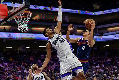 Los Angeles Clippers guard Kobe Sanders (4) shoots over Sacramento Kings center Dylan Cardwell (32) during the second half of an NBA basketball game in Sacramento, California.