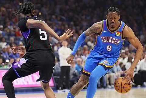 Oklahoma City Thunder guard Jalen Williams (8) dribbles around Utah Jazz forward Cody Williams during the first half of an NBA basketball game in Oklahoma City.