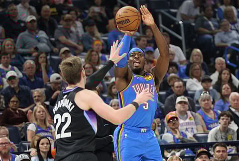 Oklahoma City Thunder guard Luguentz Dort (5) looks to shoot over Utah Jazz forward Kyle Filipowski (22) during the first half of an NBA basketball game in Oklahoma City. 