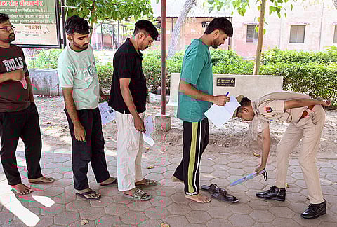 Candidates undergo security check as they arrive to appear for Rajasthan Public Service Commission (RPSC) SI Recruitment Examination, in Bikaner.