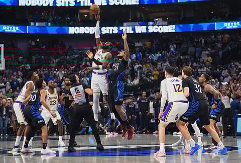 Los Angeles Lakers center Deandre Ayton (5) and Dallas Mavericks forward Daniel Gafford (21) jump for the ball at tipoff during the first half of an NBA basketball game in Dallas.