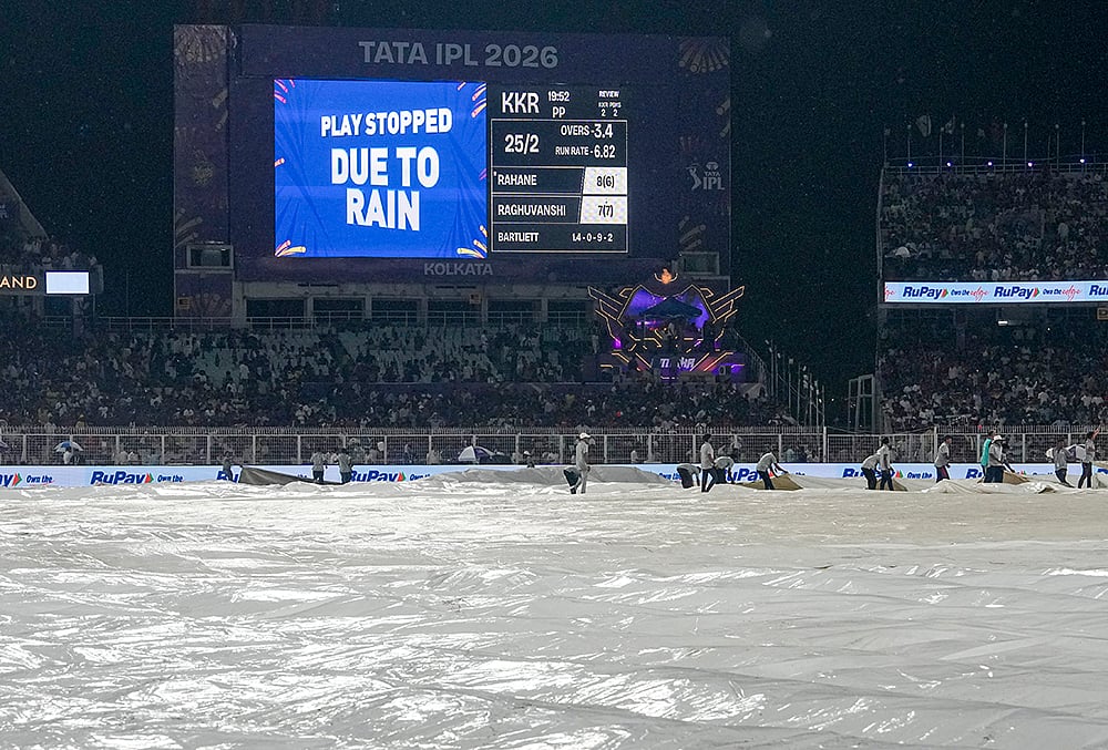 Ground staff cover the ground during rain interruption in an Indian Premier League (IPL) 2026 cricket match between Kolkata Knight Riders and Punjab Kings at Eden Gardens, in Kolkata - | Photo: PTI/Manvender Vashist Lav