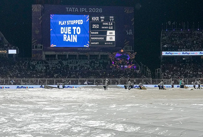 Ground staff cover the ground during rain interruption in an Indian Premier League (IPL) 2026 cricket match between Kolkata Knight Riders and Punjab Kings at Eden Gardens, in Kolkata - | Photo: PTI/Manvender Vashist Lav