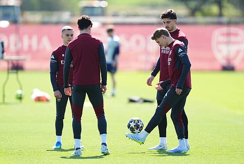 Arsenal's Martin Odegaard, right, and team-mates practice during a training session in London, one day ahead of their Champions League, first leg, quarter-final soccer match against Sporting Lisboa.