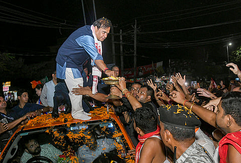 Assam Chief Minister Himanta Biswa Sarma greets the supporters during a roadshow in support of NDA alliance AGP-BJP candidate Prithiraj Rabha for the upcoming Assam Assembly elections, in Tezpur.
