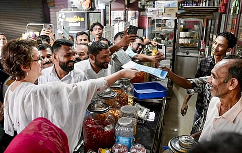 Congress general secretary and Wayanad MP Priyanka Gandhi Vadra distributes UDF guarantee pamphlets during a campaign ahead of Assembly elections at Mampad in Wandoor, in Malappuram district, Kerala. 