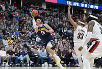 | Photo: AP/David Zalubowski : Denver Nuggets center Nikola Jokić, left, falls as he puts up a shot after being fouled by Portland Trail Blazers forward Toumani Camara, back right, as center Robert Williams III looks on in the second half of an NBA basketball game in Denver. 