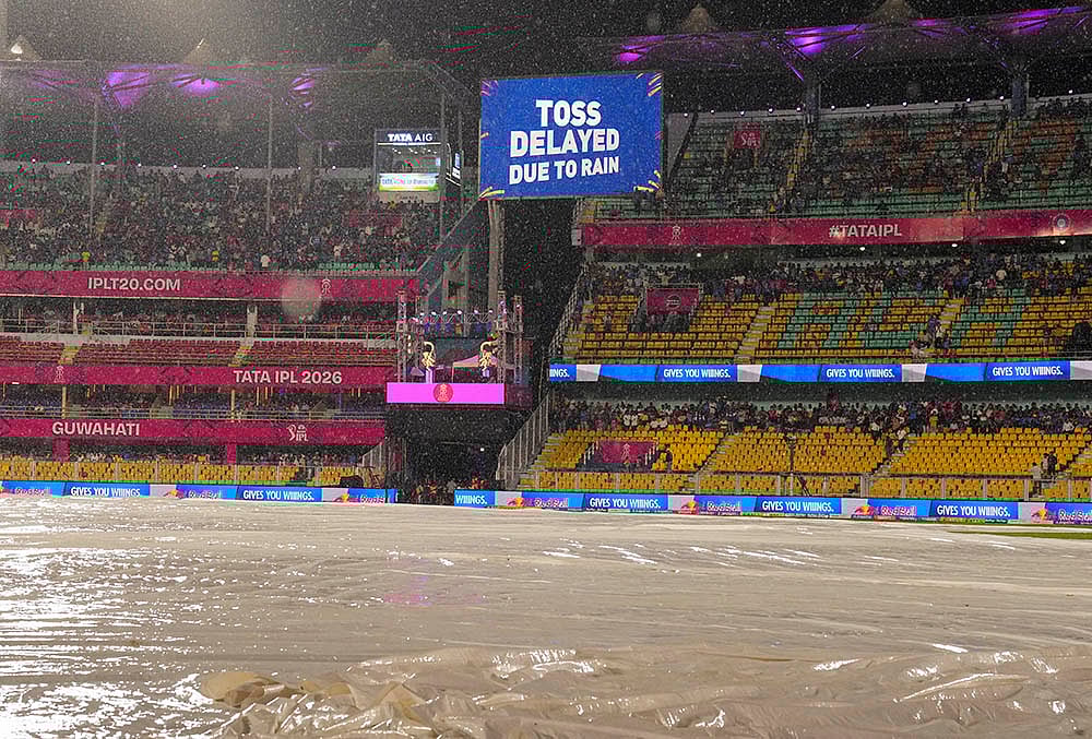 View of the ground covered due to rain as a screen displays 'Toss delayed due to rain' during an Indian Premier League (IPL) 2026 T20 cricket match between Rajasthan Royals and Mumbai Indians, in Guwahati. - | Photo: PTI/Swapan Mahapatra