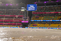 | Photo: PTI/Swapan Mahapatra : View of the ground covered due to rain as a screen displays 'Toss delayed due to rain' during an Indian Premier League (IPL) 2026 T20 cricket match between Rajasthan Royals and Mumbai Indians, in Guwahati.