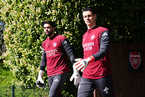 Arsenal goalkeepers Kepa Arrizabalaga, right, and David Raya arrive for a training session in Londo.