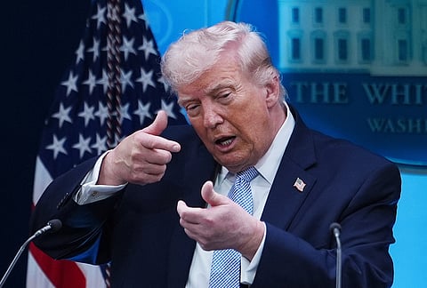 US President Donald Trump pretends to aim a sniper gun while speaking with reporters in the James Brady Press Briefing Room at the White House in Washington. 