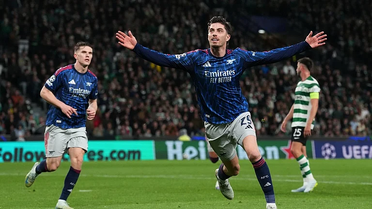 Arsenal's Kai Havertz celebrates after scoring his sides first goal during the Champions League quarterfinals, first leg, soccer match between Sporting CP and Arsenal, in Lisbon, Tuesday, April 7, 2026. - AP Photo/Armando Franca