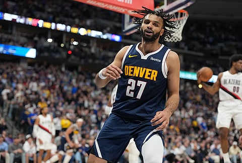 Denver Nuggets guard Jamal Murray reacts after making a driving basket late in overtime of an NBA basketball game against the Portland Trail Blazers, in Denver. 