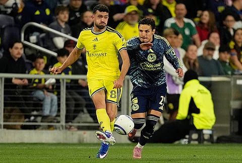 Nashville SC midfielder Patrick Yazbek (8) kicks the ball past Club America midfielder Raphael Veiga (23) during the first half of an CONCACAF Champions Cup first leg quarterfinal soccer match in Nashville, Tennessee.