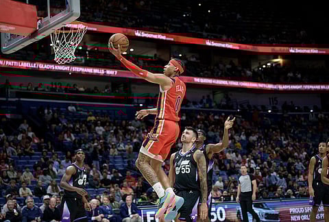 New Orleans Pelicans guard Jeremiah Fears (0) shoots against Utah Jazz guard John Konchar (55) during the second half of an NBA basketball game in New Orleans.