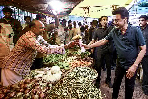 Tamil Nadu Chief Minister and DMK candidate from Kolathur constituency, MK Stalin, interacts with a vegetable vendor during a voter outreach ahead of the state Assembly elections, in Tiruvannamalai.