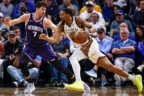 Golden State Warriors' De'Anthony Melton (8) drives the basket against Doug McDermott (7) of the Sacramento Kings in the second half of a basketball game at Chase Center in San Francisco.