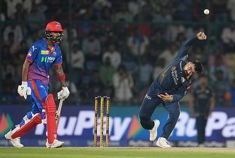 Gujarat Titans' Rashid Khan bowls a delivery during the Indian Premier League cricket match between Delhi Capitals and Gujarat Titans in New Delhi.