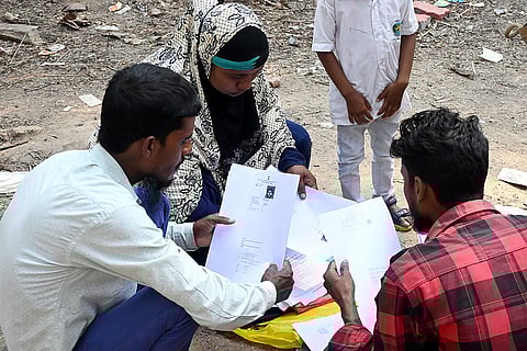 People wait to submit their petitions before the Special Tribunal after their names were deleted from the Special Intensive Revision final voter list ahead of West Bengal Assembly Election, at Ranaghat, in Nadia district.