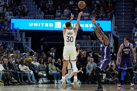 Golden State Warriors guard Stephen Curry (30) shoots a 3-point basket over Sacramento Kings forward Precious Achiuwa (9) during the first half of an NBA basketball game in San Francisco.