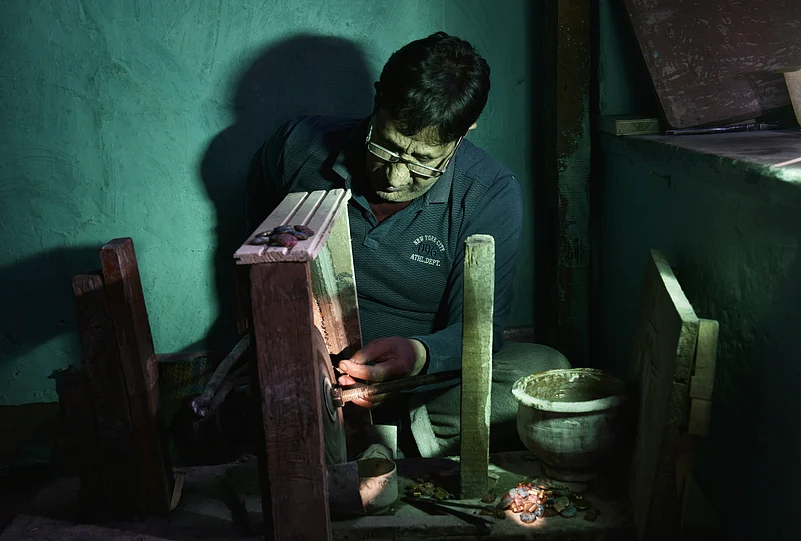 A Kashmiri handicraft worker in his workstation
