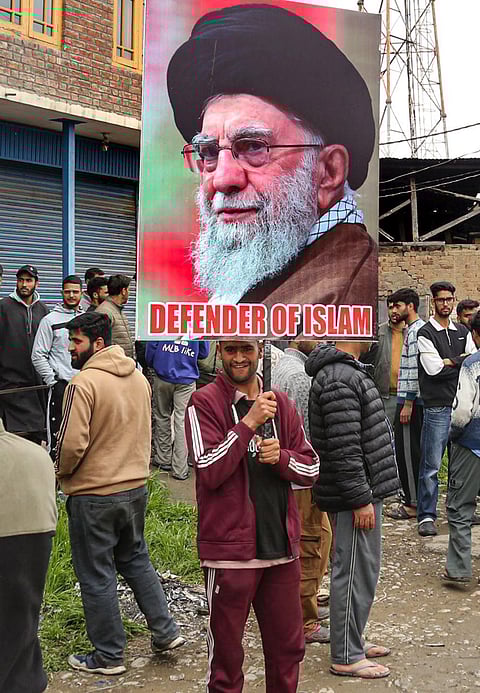 People raise slogans and hold a portrait of late Iran's Supreme Leader Ayatollah Ali Khamenei, in response to the ceasefire agreement between Iran, the United States and Israel, after US President Donald Trump pulled back from his threats to destroy Iranian civilization, in Srinagar, Jammu and Kashmir.