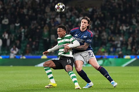Arsenal's Riccardo Calafiori, right, challenges Sporting's Geny Catamo during the Champions League quarterfinals, first leg, soccer match between Sporting CP and Arsenal, in Lisbon.