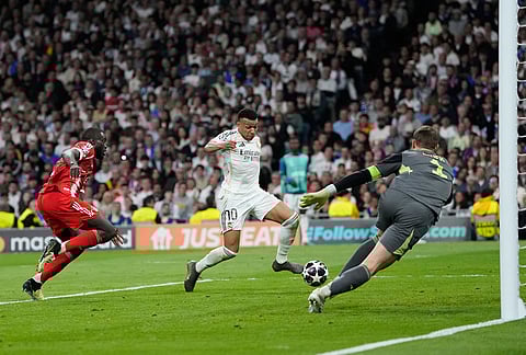 Real Madrid's Kylian Mbappe scores his side's opening goal during the Champions League quarterfinal first leg soccer match between Real Madrid and Bayern Munich in Madrid, Spain.