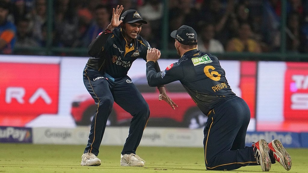 Gujarat Titans' Glenn Phillips, right, celebrates after taking catch to dismiss Delhi Capitals' captain Axar Patel during their Indian Premier League match in New Delhi. - AP/Manish Swarup