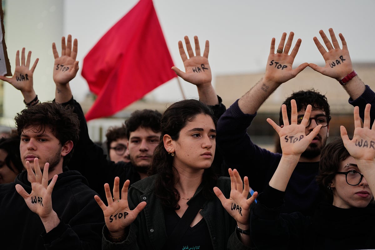 People raise their hands during a protest calling for an end to the war in Tel Aviv, Israel, Saturday, April 4, 2026.  
Source: AP
 - MAYA LEVIN