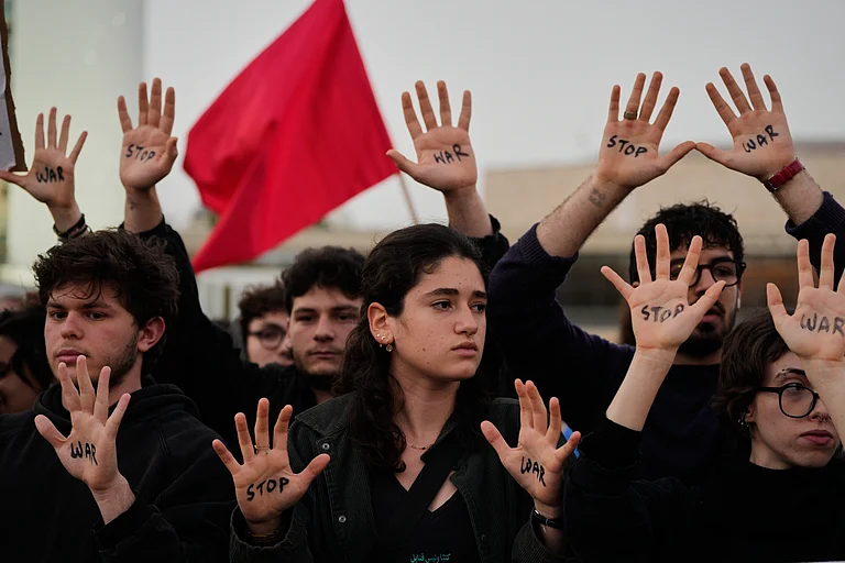 People raise their hands during a protest calling for an end to the war in Tel Aviv, Israel, Saturday, April 4, 2026.
Source: AP
- MAYA LEVIN