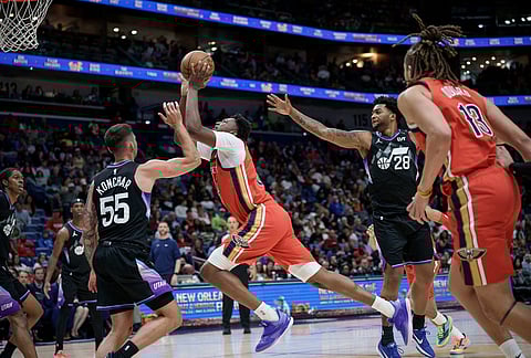 New Orleans Pelicans center Derik Queen (22) shoots against Utah Jazz guard John Konchar (55) during the second half of an NBA basketball game in New Orleans.