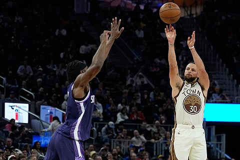 Golden State Warriors guard Stephen Curry (30) shoots a 3-point basket over Sacramento Kings forward Precious Achiuwa (9) during the second half of an NBA basketball game in San Francisco.