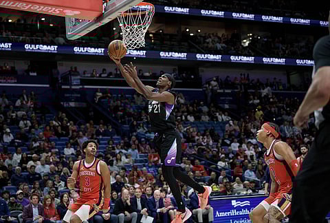 Utah Jazz guard Bez Mbeng (21) shoots against New Orleans Pelicans guard Jordan Poole (3) of an NBA basketball game in New Orleans.