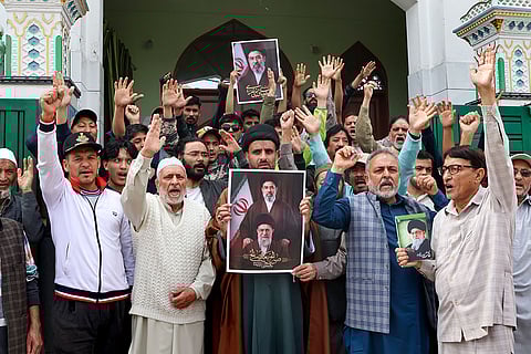 People raise slogans and hold portraits of late Iran's Supreme Leader Ayatollah Ali Khamenei, in view of the two-week ceasefire agreement between Iran, the United States and Israel, in Jammu.
