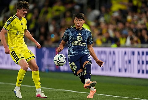 Club America defender Miguel Vazquez, right, kicks the ball past Nashville SC midfielder Matthew Corcoran, left, during the first half of an CONCACAF Champions Cup first leg quarterfinal soccer match in Nashville, Tennessee.

