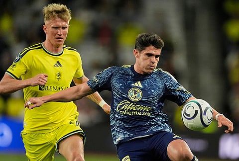 Club America defender Israel Reyes, right, kicks the ball past Nashville SC forward Sam Surridge, left, during the second half of an CONCACAF Champions Cup first leg quarterfinal soccer match in Nashville, Tennessee.